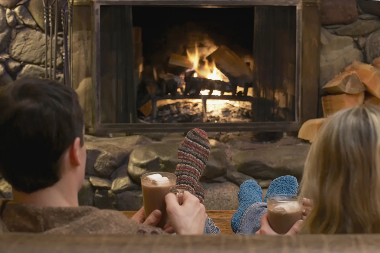 Aprés ski couple relaxing by a fire